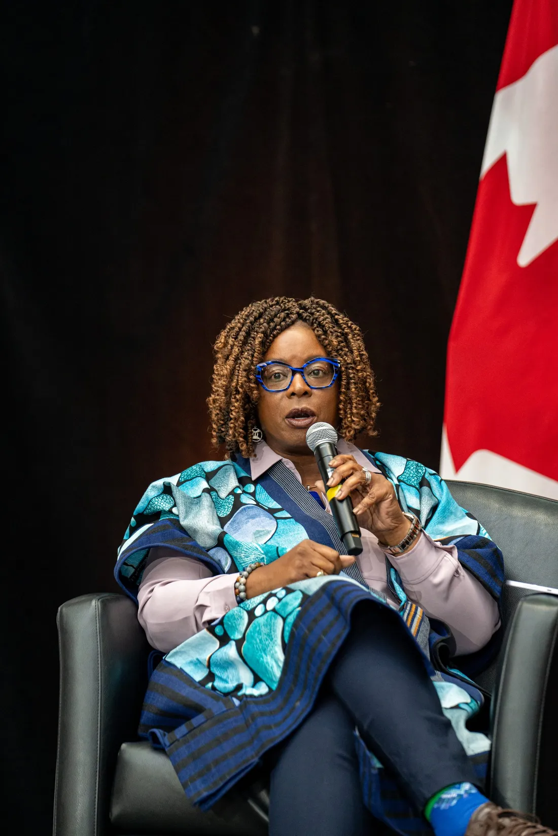 Dr. Helen Ofosu on stage speaking at Rising 2025 conference